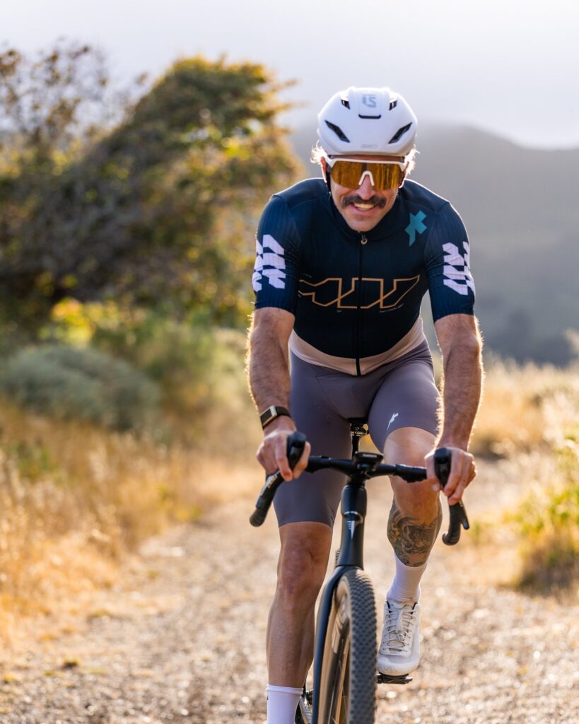 Rider on a gravel bike climbing a gravel path toward the camera