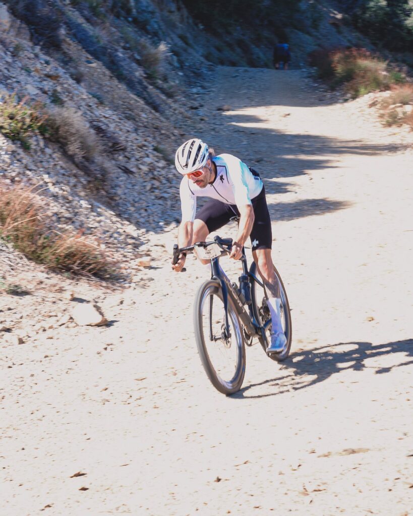 Rider on a pale, sandy mountain trail